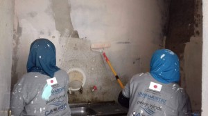 Women painting the kitchen wall