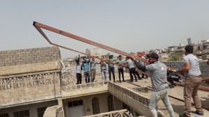 Welders installing roof frame