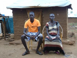 Figure  SEQ Figure \* ARABIC 1 Joyce Abau with one of her sons Infront of their makeshift house before PWJ shelter support